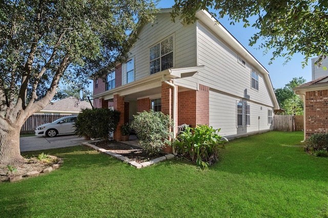 view of side of home with a yard