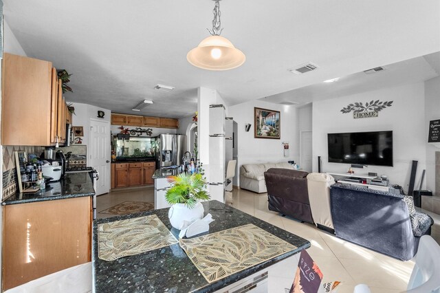 tiled dining space featuring sink