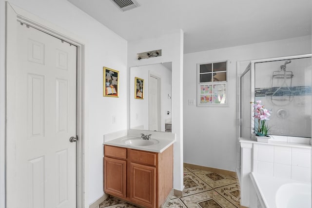 bathroom featuring tile patterned floors, vanity, and independent shower and bath