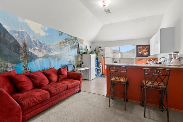 carpeted living room featuring vaulted ceiling