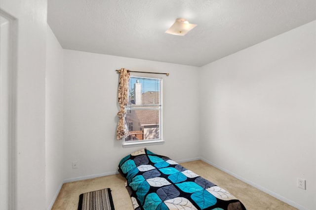 unfurnished room featuring light colored carpet and a textured ceiling