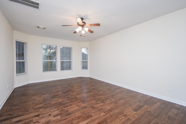 unfurnished room with ceiling fan and dark hardwood / wood-style flooring