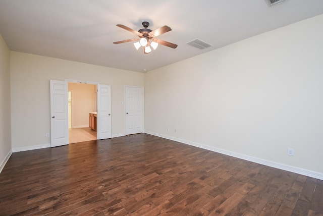 spare room with dark hardwood / wood-style floors and ceiling fan