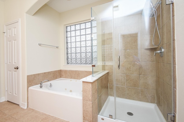 bathroom with tile patterned floors and independent shower and bath