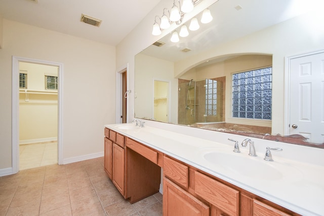 bathroom with tile patterned floors, vanity, and an enclosed shower