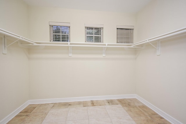 walk in closet with light tile patterned floors