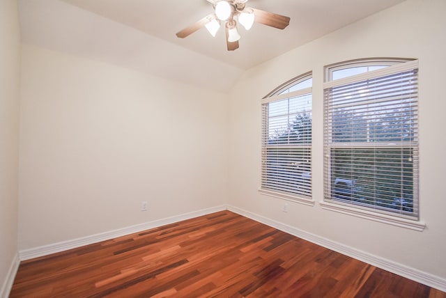 empty room featuring lofted ceiling, ceiling fan, and dark hardwood / wood-style floors