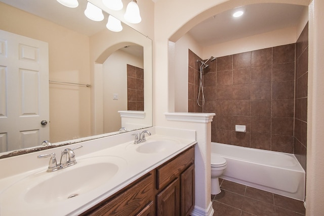 full bathroom featuring toilet, vanity, tile patterned floors, and tiled shower / bath