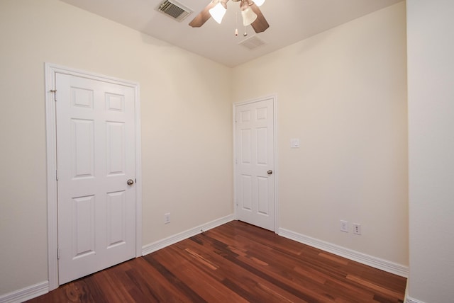 spare room with dark hardwood / wood-style floors and ceiling fan