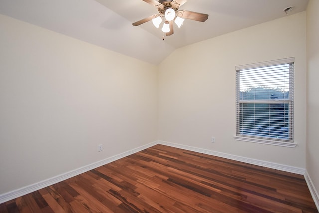 unfurnished room with dark hardwood / wood-style floors, vaulted ceiling, and ceiling fan