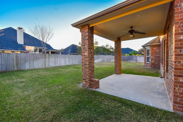 view of yard featuring ceiling fan and a patio