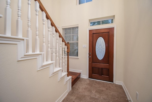 foyer entrance with dark tile patterned floors