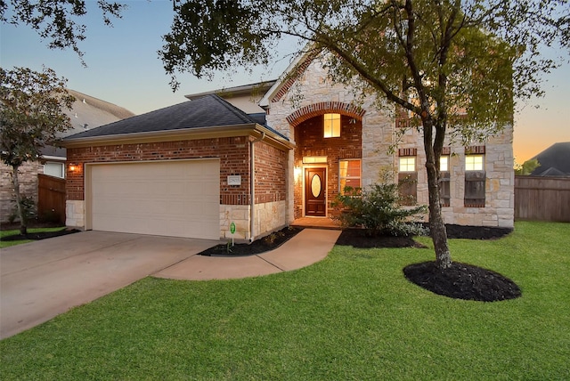 view of front of property with a yard and a garage