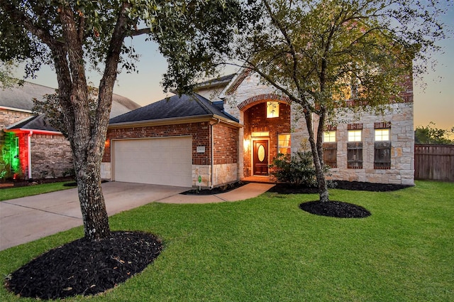 view of front of home with a yard and a garage