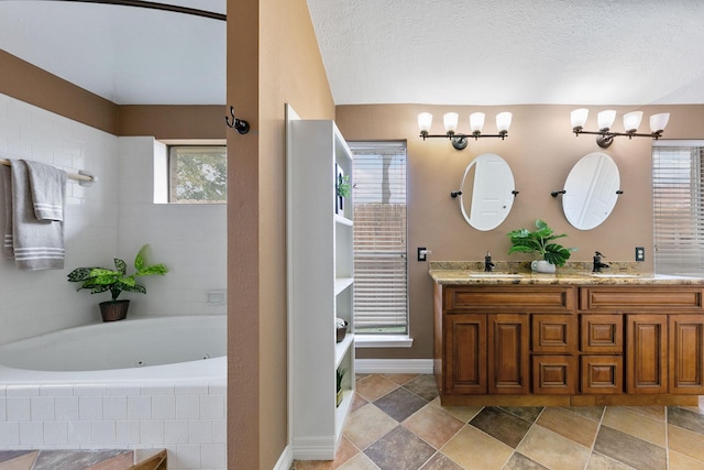 2931 Carrizo Springs Ct, Katy, TX 77449 - bathroom with double vanity, a jetted tub, and baseboards