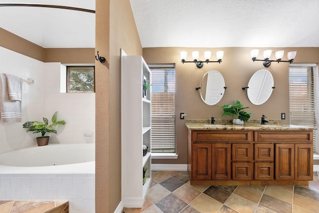 2931 Carrizo Springs Ct, Katy, TX 77449 - bathroom featuring a bath, double vanity, and baseboards