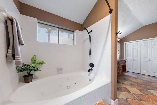 2931 Carrizo Springs Ct, Katy, TX 77449 - bathroom featuring lofted ceiling and a combined bath / shower with jetted tub