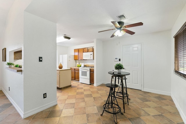 kitchen featuring ceiling fan and white appliances