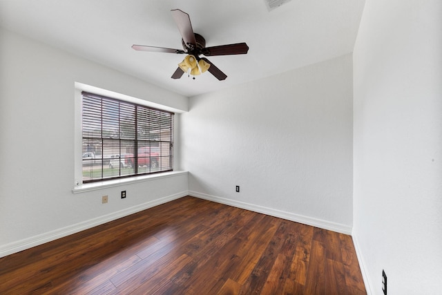 unfurnished room with ceiling fan and dark wood-type flooring