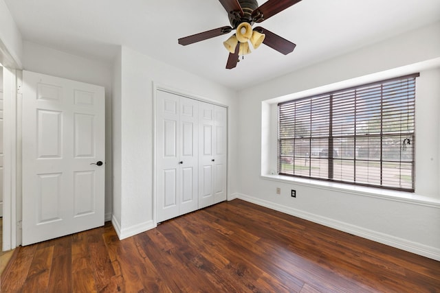 2931 Carrizo Springs Ct, Katy, TX 77449 - unfurnished bedroom featuring baseboards, dark wood finished floors, a closet, and ceiling fan