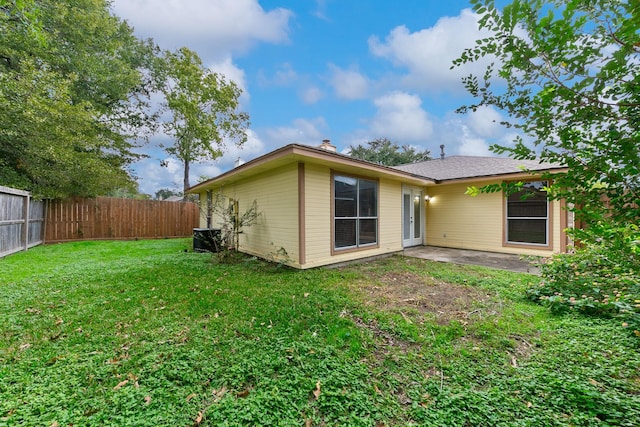 rear view of property with a patio area and a lawn