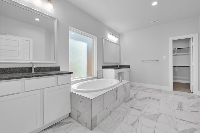 23411 Persimmon Creek Ln, Katy, TX 77493 - bathroom featuring vanity and a relaxing tiled tub
