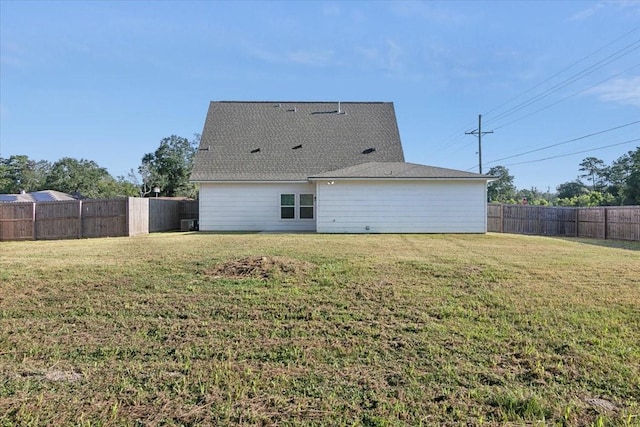 rear view of house with a lawn