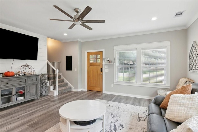 living room with crown molding, hardwood / wood-style floors, and ceiling fan