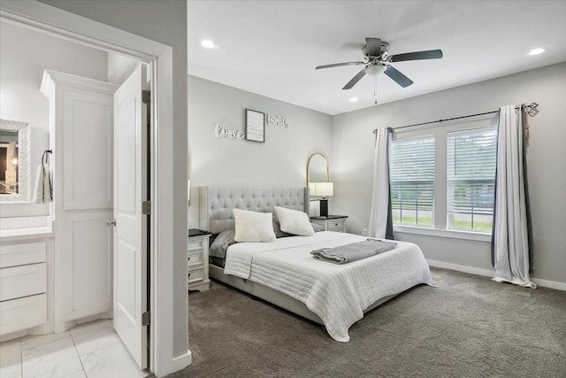 carpeted bedroom with ceiling fan and connected bathroom