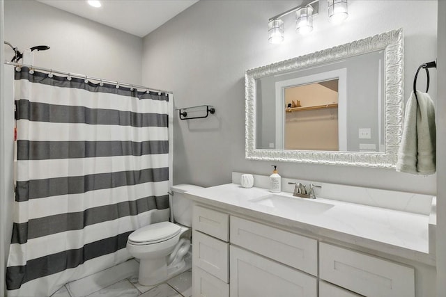 bathroom featuring vanity, toilet, and walk in shower