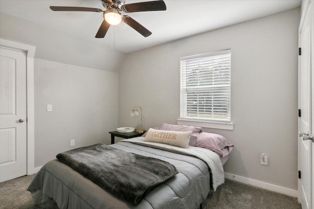 bedroom with dark colored carpet, ceiling fan, and lofted ceiling