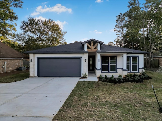 view of front of house with a front yard and a garage