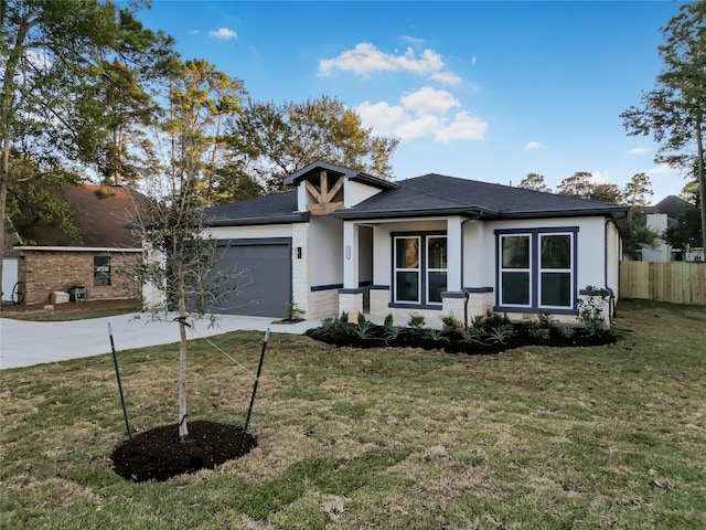 view of front of home featuring a front lawn and a garage