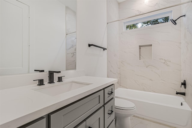 full bathroom with vanity, tiled shower / bath combo, and toilet