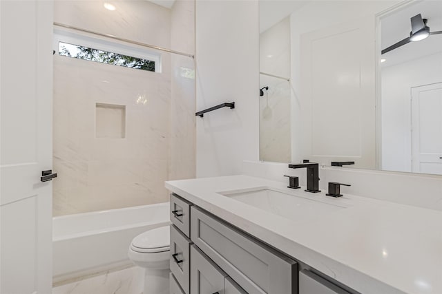 full bathroom with tiled shower / bath combo, toilet, and vanity