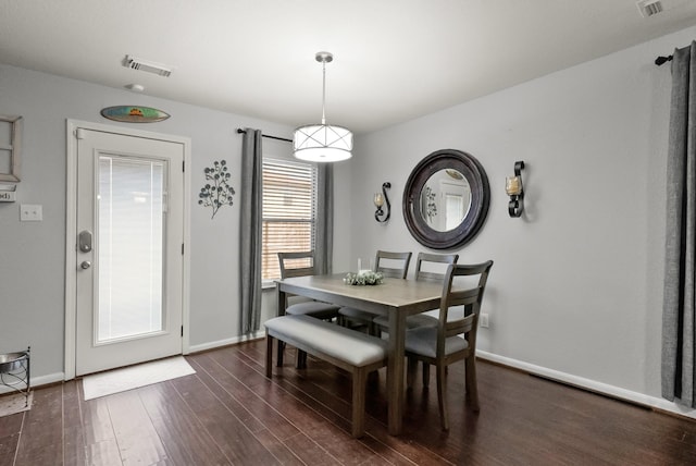 dining space with dark wood finished floors, baseboards, and visible vents