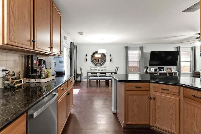 kitchen featuring visible vents, plenty of natural light, stainless steel dishwasher, and dark wood-style floors