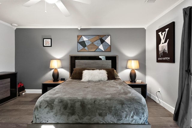 bedroom featuring dark wood-type flooring, baseboards, and ornamental molding