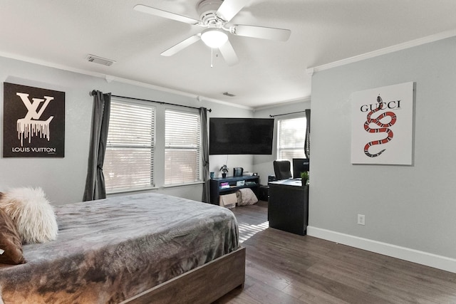 bedroom featuring a ceiling fan, baseboards, wood finished floors, visible vents, and ornamental molding