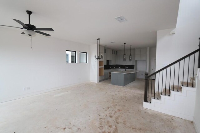 3411 Loam Ln, Richmond, TX 77406 - unfurnished living room featuring stairs, ceiling fan, and concrete floors