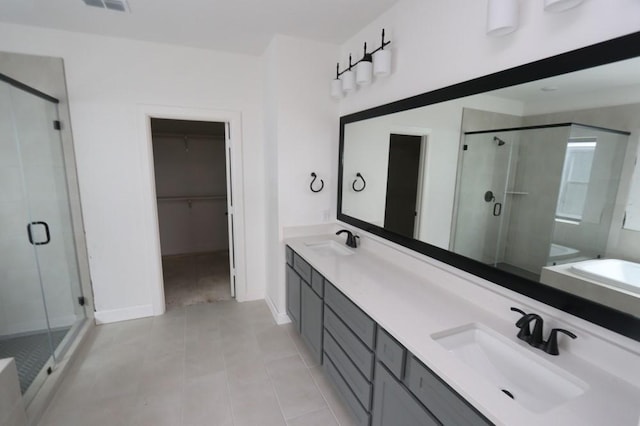 bathroom with plus walk in shower, tile patterned flooring, and vanity