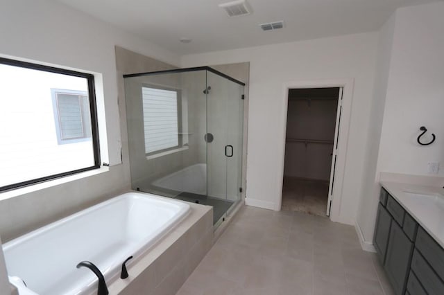 bathroom featuring shower with separate bathtub and vanity