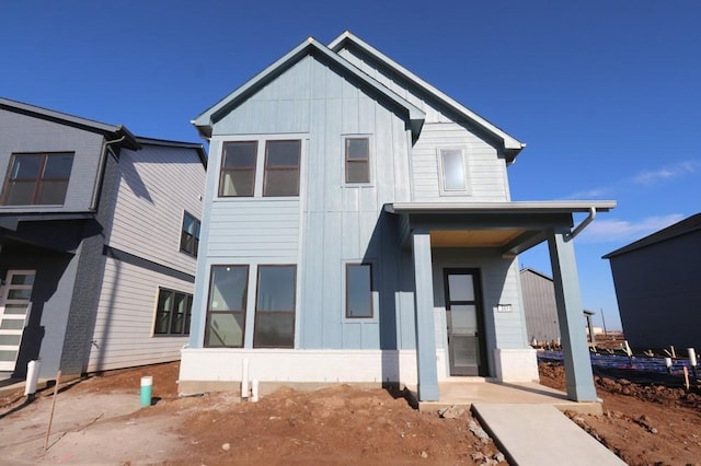 rear view of house featuring board and batten siding