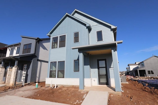 view of front of home featuring board and batten siding and central AC unit