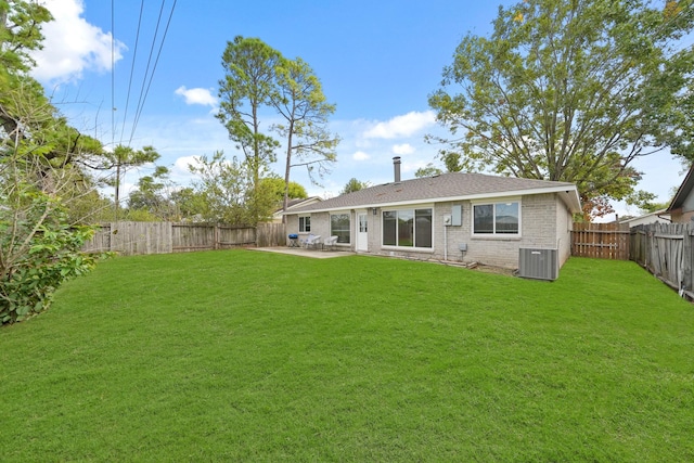 back of property featuring central air condition unit, a lawn, and a patio