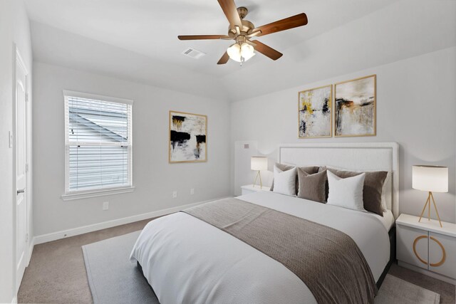 carpeted bedroom featuring ceiling fan and vaulted ceiling