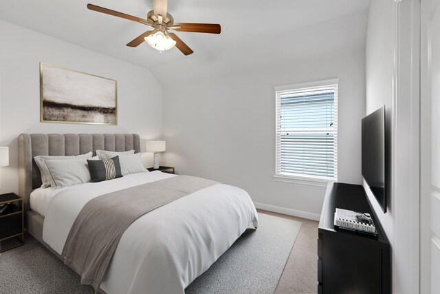 carpeted bedroom featuring ceiling fan and lofted ceiling