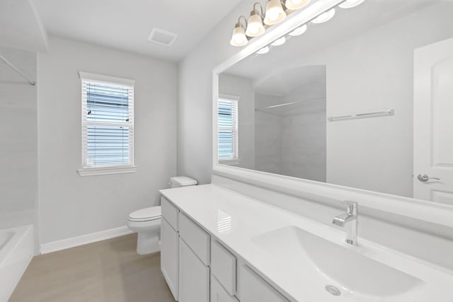 bathroom with hardwood / wood-style floors, vanity, and toilet