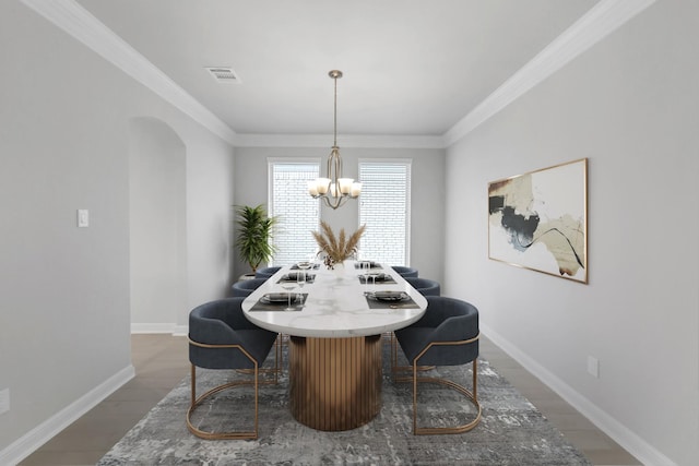 dining area with a chandelier, dark hardwood / wood-style floors, and crown molding