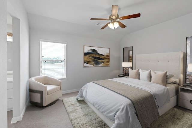 carpeted bedroom with ceiling fan and vaulted ceiling